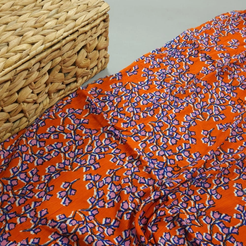 Orange shade base small abstract flower jaal print on overall fabric, rayon crepe fabric.