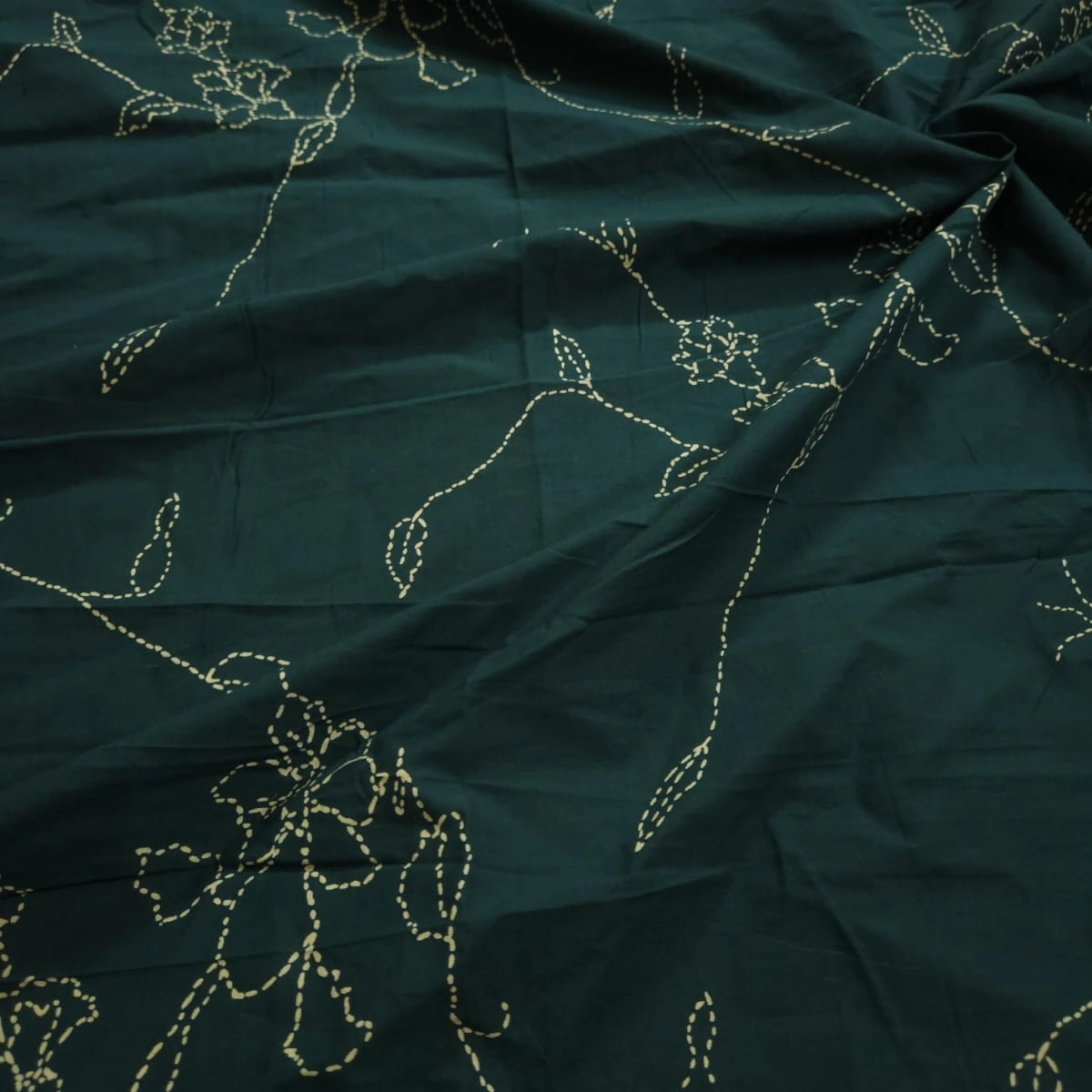 Bottle green shade base flowers jaal print on overall fabric, cotton fabric.